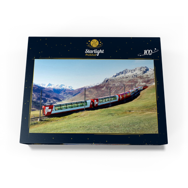 An express with panoramic windows overlooking the meadows on the mountains and snow-capped mountains under blue sunny sky in Andermatt, Uri, Switzerland 100 Jigsaw Puzzle box view1