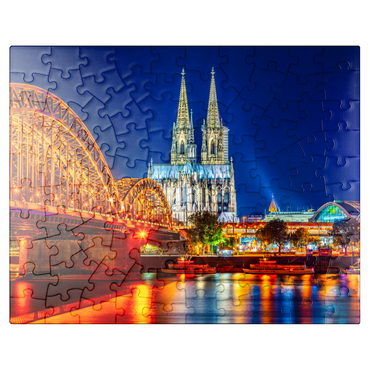 puzzleplate Night view of Cologne Cathedral and Hohenzollern Bridge over Rhine, Germany 100 Jigsaw Puzzle