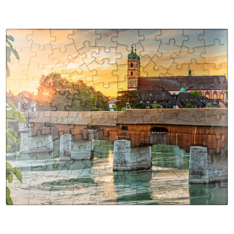 puzzleplate Covered wooden bridge and Fridolinsmünster in Bad Säckingen at sunset 100 Jigsaw Puzzle