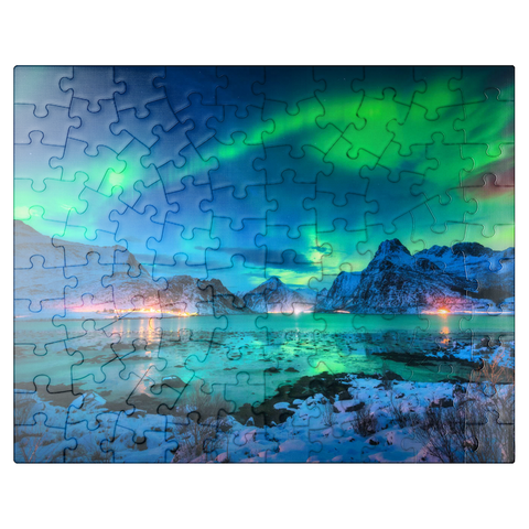 puzzleplate Aurora borealis over sea coast, snow covered mountains and city lights at night. Northern lights on Lofoten Islands, Norway. Starry sky with aurora borealis. Winter landscape with aurora reflected in water. 100 Jigsaw Puzzle