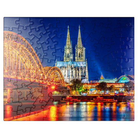 puzzleplate Night view of Cologne Cathedral and Hohenzollern Bridge over Rhine, Germany 100 Jigsaw Puzzle